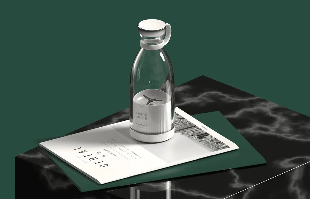 Clear glass carafe with white base on a dark marble surface with a magazine underneath