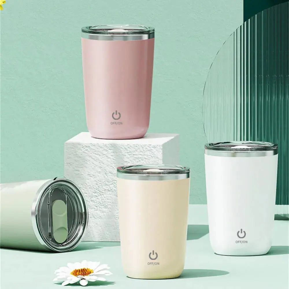 Set of four insulated tumblers in pink, beige, and white on a light green background.
