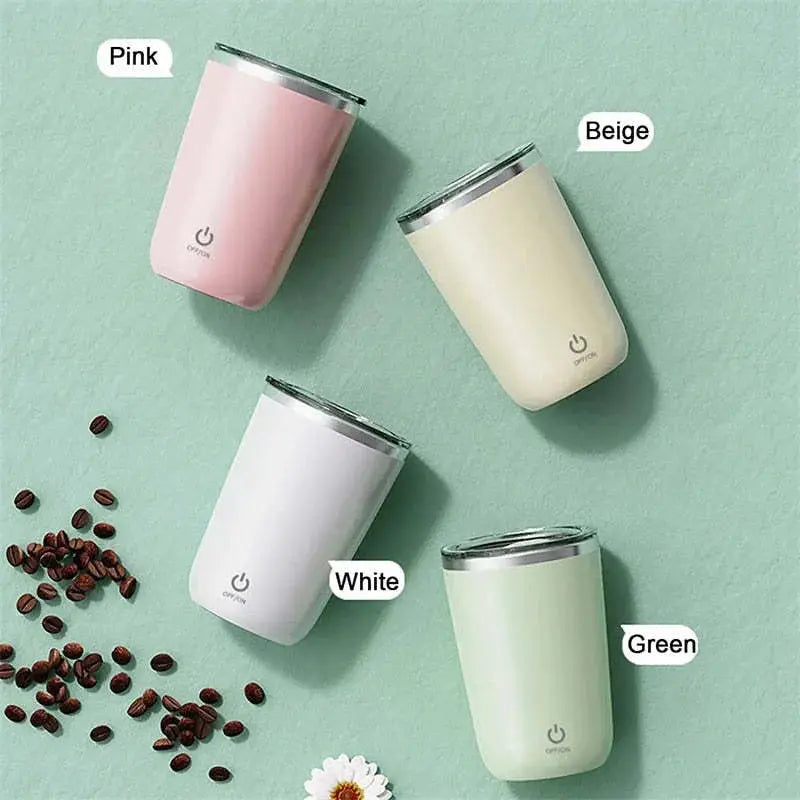 Four colorful travel mugs on a light green background with coffee beans and a flower.