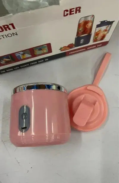 Pink container with a lid on a white surface, with a box labeled 'CER' in the background.
