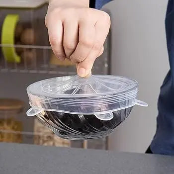 Person holding a transparent lid over a container with a blurred background