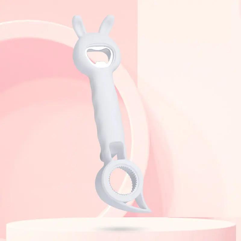 White cat-shaped bottle opener on a pink background