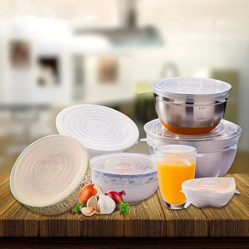 Set of silicone food covers on a kitchen counter with various items.
