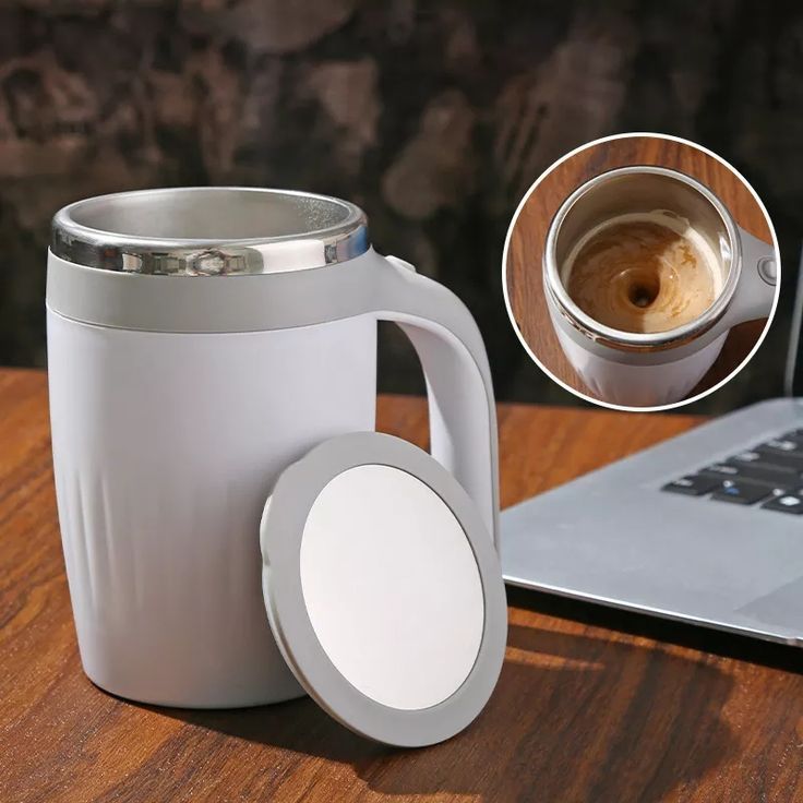 White insulated mug with handle on a wooden surface next to a laptop, with an inset showing the interior.