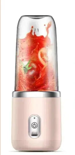 Personal blender with a glass container filled with a red smoothie on a white background