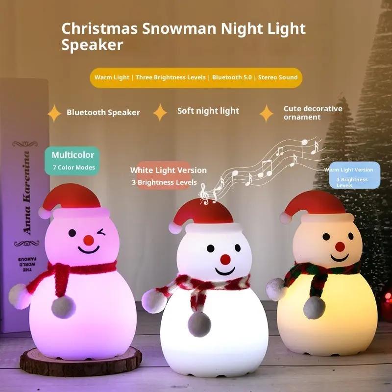 Christmas snowman night light speaker with multicolor and white light options on a wooden surface.