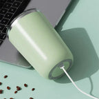 Green USB device on a light green surface with a laptop in the background